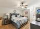 Spacious main bedroom featuring a ceiling fan, and an en suite bathroom at 11350 Copley Ct, Spring Hill, FL 34609
