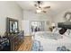 Spacious main bedroom featuring a ceiling fan, a sliding glass door to a private area at 11350 Copley Ct, Spring Hill, FL 34609