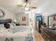 Spacious main bedroom featuring a ceiling fan, and an en suite bathroom at 11350 Copley Ct, Spring Hill, FL 34609