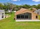 Expansive screened lanai in a well-maintained backyard with mature landscaping, perfect for outdoor entertaining at 11350 Copley Ct, Spring Hill, FL 34609