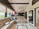Large sunroom with a tan couch, tile floor and vaulted ceilings at 11350 Copley Ct, Spring Hill, FL 34609