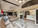 View of the sunroom showcasing the tan couch, tile floor and vaulted ceilings at 11350 Copley Ct, Spring Hill, FL 34609