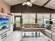 Bright sunroom with tan walls and tile floors, featuring a comfortable tan couch at 11350 Copley Ct, Spring Hill, FL 34609