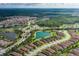 Bird's eye view of a well-maintained community with mature trees, small lakes, and sidewalks connecting all the homes at 11611 Callisia Dr, Odessa, FL 33556