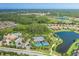 Panoramic aerial view of the community featuring lakes, pools, tennis courts, and lush greenery at 11611 Callisia Dr, Odessa, FL 33556