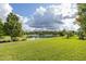 Expansive backyard with lush green grass and a serene lake view for peaceful relaxation at 11611 Callisia Dr, Odessa, FL 33556
