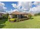 Spacious backyard featuring a screened lanai and lush landscaping for outdoor enjoyment at 11611 Callisia Dr, Odessa, FL 33556