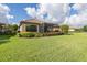 Spacious backyard featuring a screened lanai and lush landscaping for outdoor enjoyment at 11611 Callisia Dr, Odessa, FL 33556