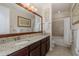 This bathroom features granite counters, dark cabinets, and a shower-tub combo at 11611 Callisia Dr, Odessa, FL 33556