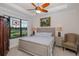 Comfortable bedroom with a large window, a ceiling fan, and neutral decor, creating a relaxing atmosphere at 11611 Callisia Dr, Odessa, FL 33556
