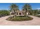 Stunning clubhouse surrounded by manicured landscaping and brick-paved roundabout at 11611 Callisia Dr, Odessa, FL 33556