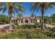 Beautiful clubhouse entrance, framed by palm trees and lush landscaping at 11611 Callisia Dr, Odessa, FL 33556