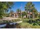 Beautiful clubhouse exterior with stone accents, mature landscaping and brick drive on a sunny day at 11611 Callisia Dr, Odessa, FL 33556