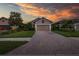 Charming single-Gathering home with a brick paved driveway and a two-car garage at 11611 Callisia Dr, Odessa, FL 33556