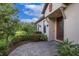 Inviting home exterior with a beautiful garden and tiled walkway at 11611 Callisia Dr, Odessa, FL 33556