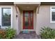 Inviting front entrance with a decorative glass door and well-maintained landscaping at 11611 Callisia Dr, Odessa, FL 33556