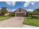 Charming single-story home with a well-maintained lawn, brick-paved driveway, and beautiful landscaping at 11611 Callisia Dr, Odessa, FL 33556