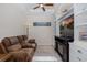 Cozy living room featuring a recliner, built-in shelving, and a television, great for relaxation at 11611 Callisia Dr, Odessa, FL 33556