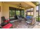 Relaxing screened patio with a ceiling fan and comfortable seating arrangements at 11611 Callisia Dr, Odessa, FL 33556