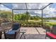 Screened patio overlooking a serene landscape at 11611 Callisia Dr, Odessa, FL 33556