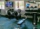 Community gym area with exercise bikes, treadmills, weights, and televisions at 11911 Bayonet Ln, New Port Richey, FL 34654