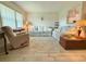 Bright living room with tile floors, comfortable seating, and lots of light from large window at 11911 Bayonet Ln, New Port Richey, FL 34654