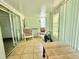 Enclosed sunroom featuring tile flooring, two chairs, and sliding glass doors at 11911 Bayonet Ln, New Port Richey, FL 34654