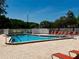 Image shows an outdoor swimming pool with lounge chairs, ideal for relaxation and recreation on sunny days at 11911 Bayonet Ln, New Port Richey, FL 34654
