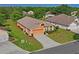Aerial view showcasing a well-maintained house with manicured lawn, landscaping, and a paved driveway at 12071 Wexford Blvd, Spring Hill, FL 34609