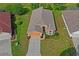Birds-eye view featuring a charming single-Gathering home with manicured lawn, beautiful landscaping, and a private driveway at 12071 Wexford Blvd, Spring Hill, FL 34609