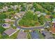 Aerial view of a residential neighborhood with mature trees, manicured lawns, and well-maintained homes at 12071 Wexford Blvd, Spring Hill, FL 34609