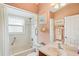 Cozy bathroom with a shower over tub, toilet, and sink at 12071 Wexford Blvd, Spring Hill, FL 34609
