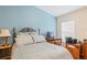 Bedroom features a double bed, desk, and neutral walls at 12071 Wexford Blvd, Spring Hill, FL 34609