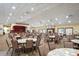 Large community center gathering space with round tables and chairs, a stage, and a fireplace at 12071 Wexford Blvd, Spring Hill, FL 34609