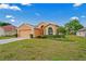 Charming single-story home featuring a well-manicured lawn and landscaping in a peaceful neighborhood at 12071 Wexford Blvd, Spring Hill, FL 34609