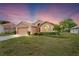 Inviting single-story home with manicured lawn and ample parking in a two-car garage at 12071 Wexford Blvd, Spring Hill, FL 34609