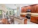 Charming kitchen with wood cabinetry, stainless steel appliances, and a breakfast bar area at 12071 Wexford Blvd, Spring Hill, FL 34609