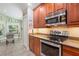 The open kitchen showcases stainless steel appliances, granite counters, and a sunlit breakfast nook at 12071 Wexford Blvd, Spring Hill, FL 34609