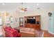 Open-concept living room with hardwood floors and media center at 12071 Wexford Blvd, Spring Hill, FL 34609