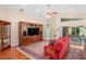 Comfortable living room featuring vaulted ceiling, fan and a large entertainment center at 12071 Wexford Blvd, Spring Hill, FL 34609