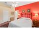 Comfortable main bedroom showcasing a bright wall, ceiling fan and hardwood flooring at 12071 Wexford Blvd, Spring Hill, FL 34609