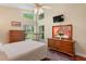 Comfortable main bedroom with large windows, and hardwood dresser and flooring at 12071 Wexford Blvd, Spring Hill, FL 34609