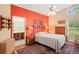 Bright main bedroom features a vivid accent wall and connecting bathroom at 12071 Wexford Blvd, Spring Hill, FL 34609