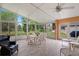 Bright sunroom with large windows, tile flooring, and a ceiling fan creates a relaxing space with views of the outdoors at 12071 Wexford Blvd, Spring Hill, FL 34609