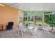 Cozy sunroom featuring tile floors, table with chairs, and large windows for natural light and lovely outdoor views at 12071 Wexford Blvd, Spring Hill, FL 34609