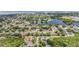 Aerial view of a quiet neighborhood featuring mature landscaping, a pond, and access to the bay at 1222 Starboard Ky, Tarpon Springs, FL 34689