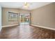 Bedroom with wood-look floors and sliding doors providing view of the pool and backyard at 1222 Starboard Ky, Tarpon Springs, FL 34689