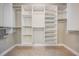 Organized walk-in closet with built-in shelving and rods, perfect for storage and organization at 1222 Starboard Ky, Tarpon Springs, FL 34689