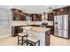 Modern kitchen with dark cabinets, granite countertops, stainless steel appliances, and a central island at 1222 Starboard Ky, Tarpon Springs, FL 34689