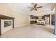 Open concept living room featuring a fireplace and a view of the kitchen with dark wood cabinets at 1222 Starboard Ky, Tarpon Springs, FL 34689